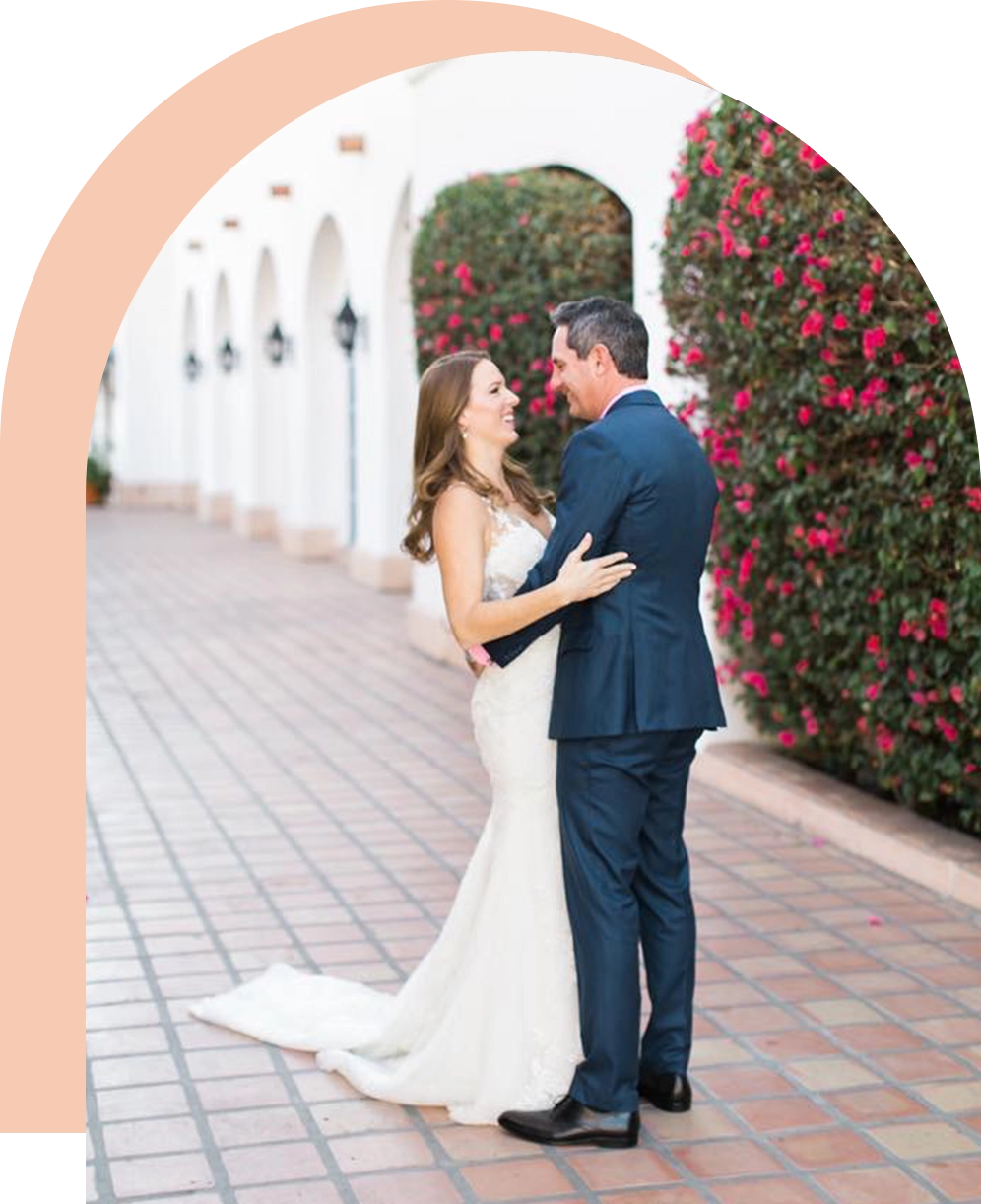 A bride and groom are posing for the camera.