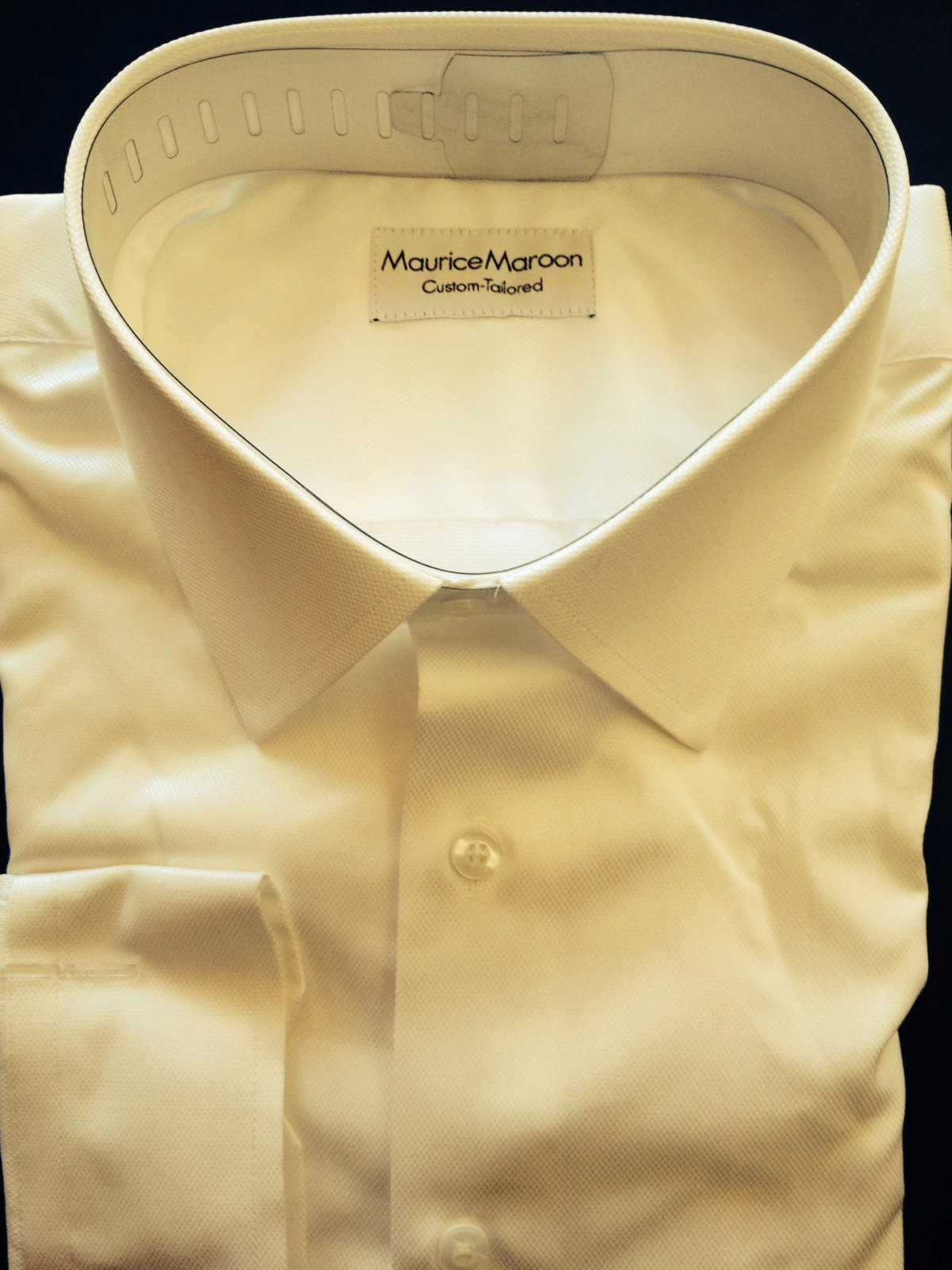 A white shirt with a black collar and cuffs.