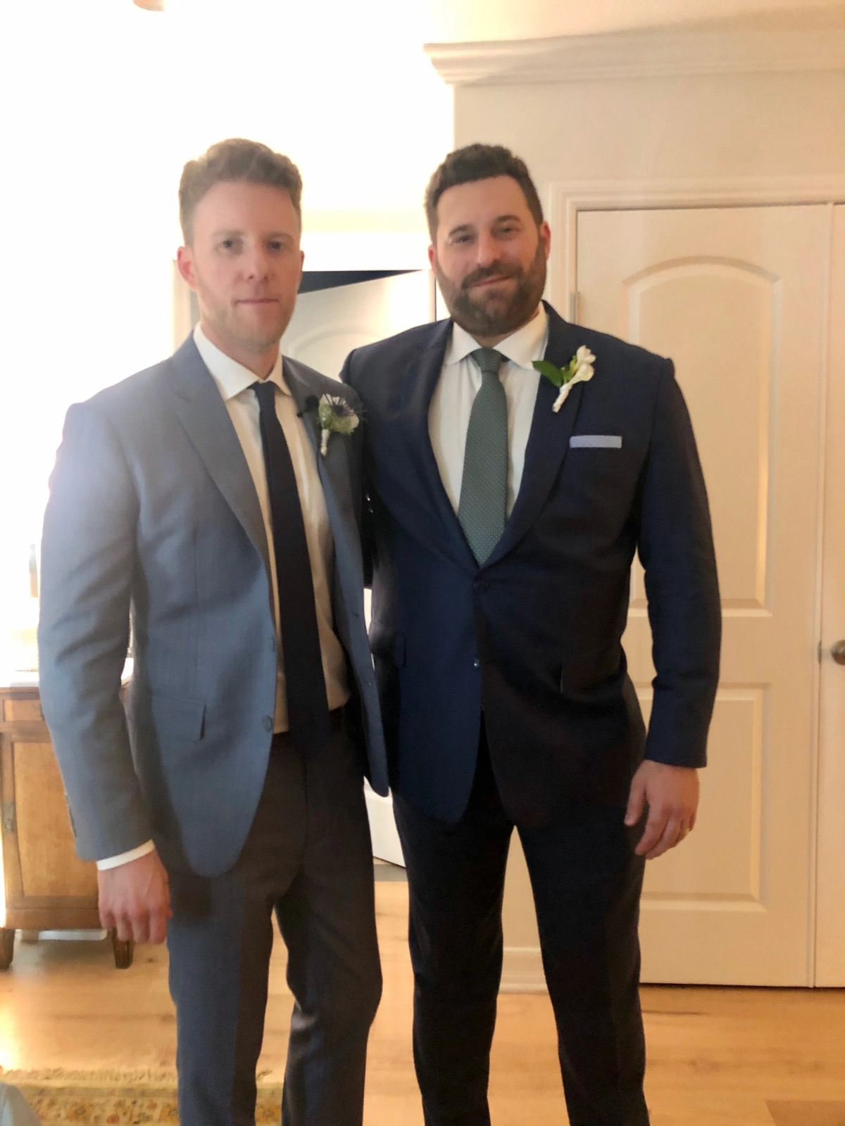 Two men in suits standing next to each other.