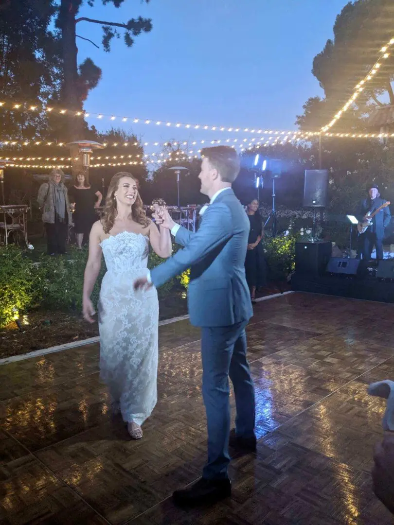 A man and woman dancing in the rain.