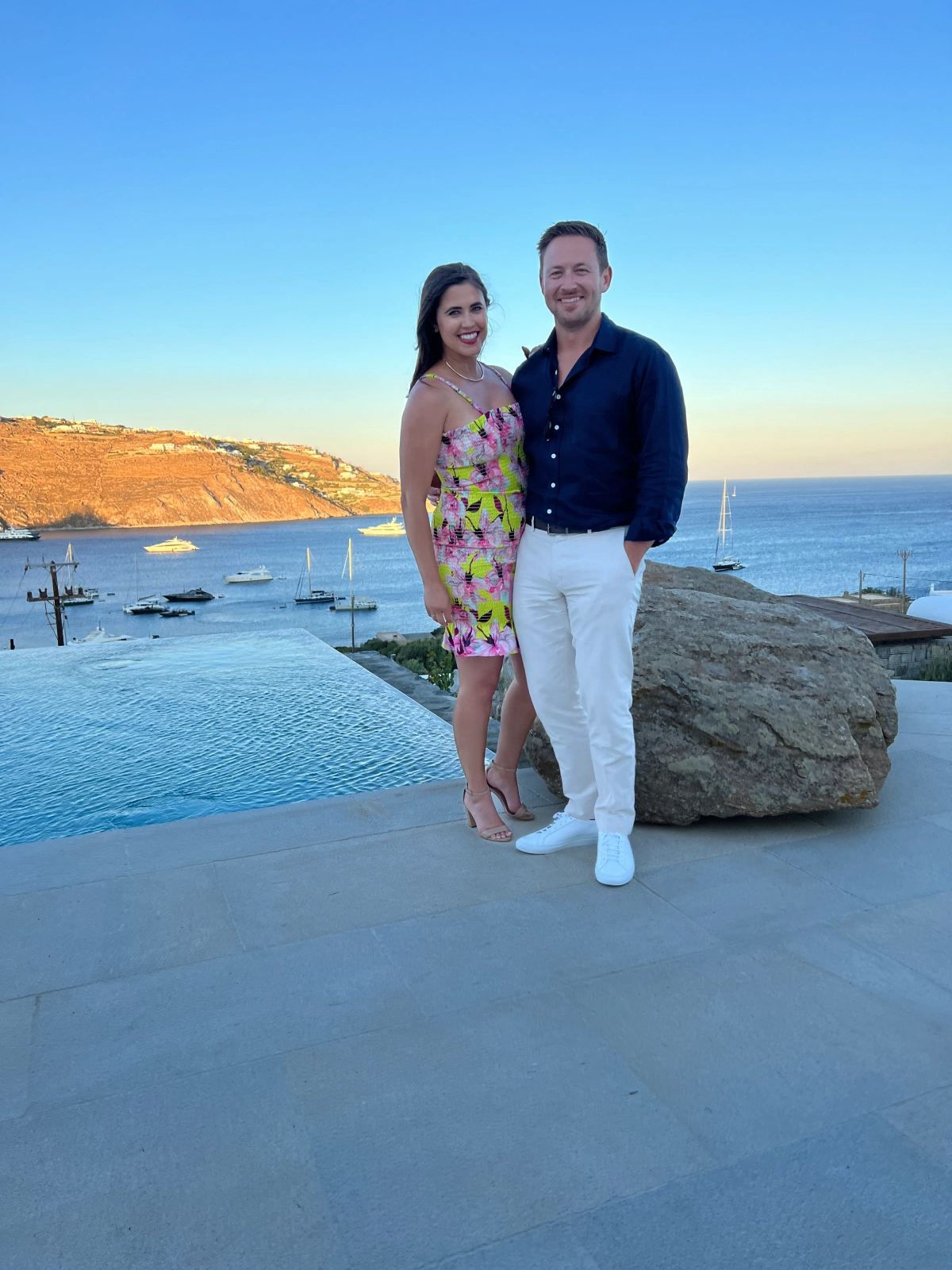 A man and woman standing next to each other on the beach.